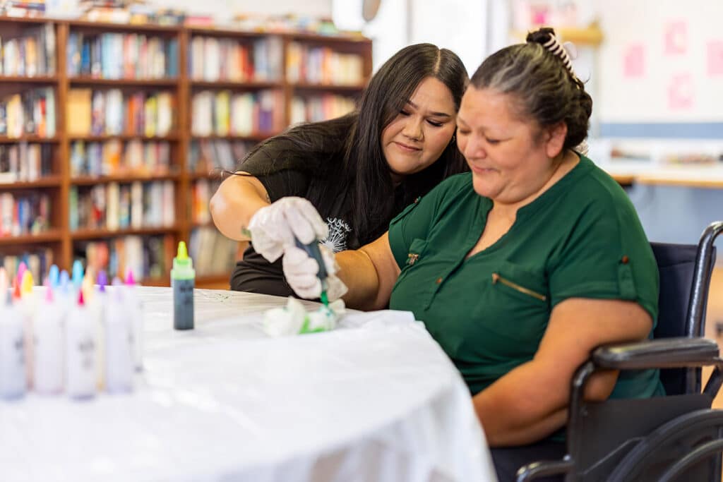Nurse doing painting activity with resident at Ahwatukee Post Acute