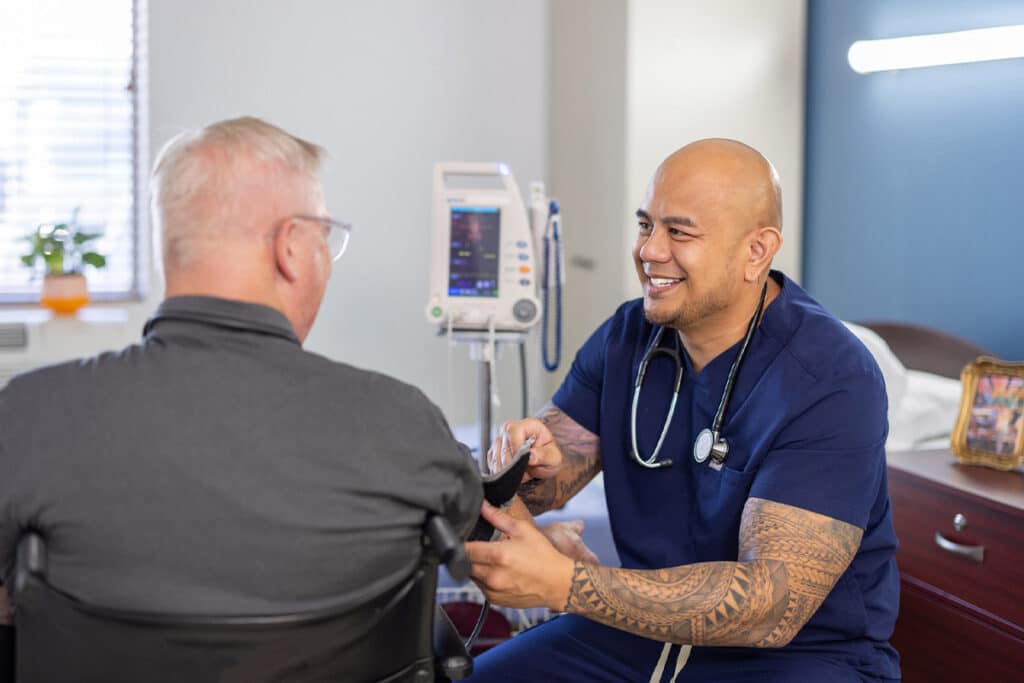 Nurse taking patient's blood pressure at Ahwatukee Post Acute