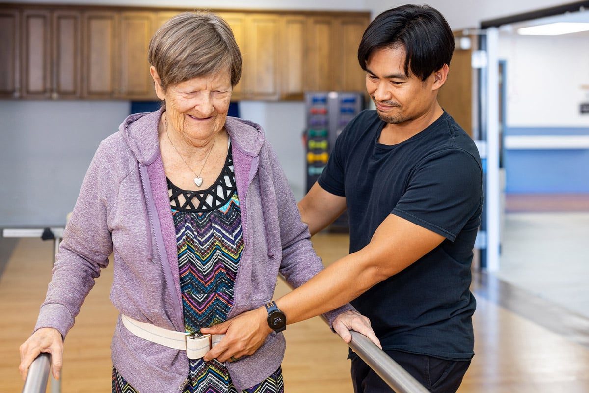 Physical therapist helping patient walk safely at Ahwatukee Post Acute
